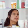 woman looking at medication