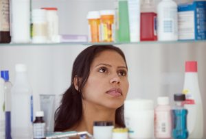 woman looking at medication