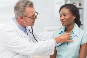 doctor checking patient