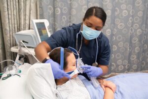 respiratory therapist with patient